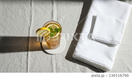 Minimalist Iced Tea with Lemon and Mint on Linen Tablecloth Minimalist Iced Tea with Lemon and Mint on Linen Tablecloth 136516790