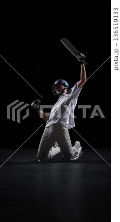 Cricket player shouting with bat raised after winning match. Cricket player shouting with bat raised after winning match. 136519133