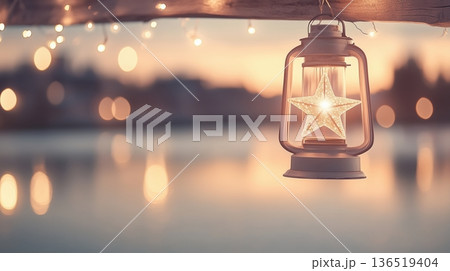 Star lantern glowing at sunset over water with bokeh lights 136519404