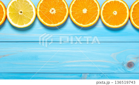 Citrus slices on a blue wooden background minimal summer concept 136519743