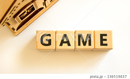 Game symbol. Concept word Game on beautiful wooden blocks. Beautiful wooden house. Beautiful white table white background. Business, lifestyle and game concept. Copy space. Game symbol. Concept word Game on beautiful wooden blocks. Beautiful wooden house. Beautiful white table white background. Business, lifestyle and game concept. Copy space. 136519837