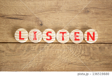 Listen symbol. Concept word Listen on beautiful wooden circles. Beautiful wooden background. Business education listen concept. Copy space. Listen symbol. Concept word Listen on beautiful wooden circles. Beautiful wooden background. Business education listen concept. Copy space. 136519880