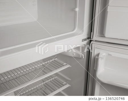 Empty refrigerator and freezer interior with open door, white shelves and storage compartments. Clean modern kitchen appliance, cold storage concept with copy space Empty refrigerator and freezer interior with open door, white shelves and storage compartments. Clean modern kitchen appliance, cold storage concept with copy space 136520746