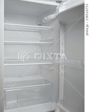 Empty clean refrigerator interior with white shelves and drawers. Minimal kitchen appliance concept, food storage space, cold storage, household technology and modern domestic lifestyle theme Empty clean refrigerator interior with white shelves and drawers. Minimal kitchen appliance concept, food storage space, cold storage, household technology and modern domestic lifestyle theme 136520753