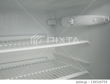 Clean empty fridge interior with adjustable thermostat dial and wire shelves. White modern refrigerator inside view, cold storage concept, minimal kitchen appliance background Clean empty fridge interior with adjustable thermostat dial and wire shelves. White modern refrigerator inside view, cold storage concept, minimal kitchen appliance background 136520754