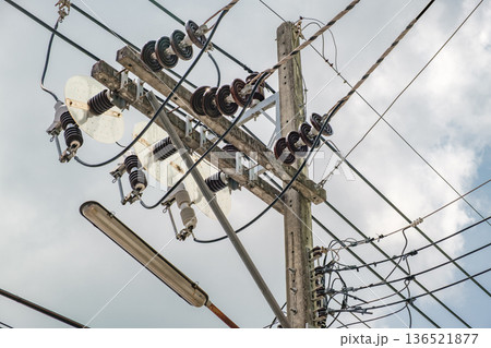 electrical wires and ceramic insulators on poles, close-up electrical wires and ceramic insulators on poles, close-up 136521877