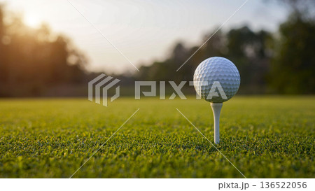 Golf ball on tee in a beautiful golf course with morning sunshine. Golf ball on tee in a beautiful golf course with morning sunshine. 136522056
