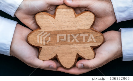 Business hands holding blank wooden decorative frame against dark background with copy space for text or design Business hands holding blank wooden decorative frame against dark background with copy space for text or design 136522963