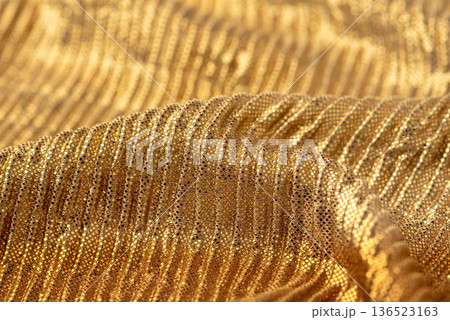 A close-up shot of gold sequin fabric for backgrounds or design elements A close-up shot of gold sequin fabric for backgrounds or design elements 136523163