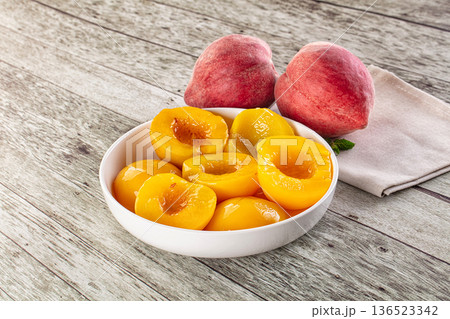 Sweet ripe yellow canned peaches Sweet ripe yellow canned peaches 136523342