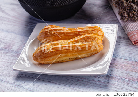 Sweet baked eclair dessert with cream Sweet baked eclair dessert with cream 136523784