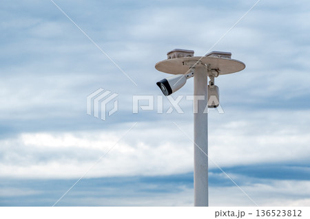 surveillance cameras mounted on a metal rod surveillance cameras mounted on a metal rod 136523812