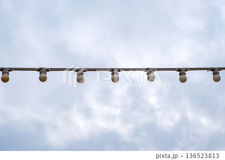 lamps on a garland against the sky 136523813