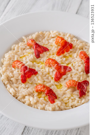 Creamy Italian risotto topped with crawfish tails and olive oil, bright gourmet styling Creamy Italian risotto topped with crawfish tails and olive oil, bright gourmet styling 136523931