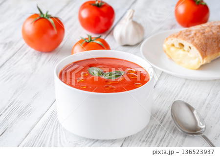 Classic tomato soup served with grilled cheese sandwich on bright rustic table Classic tomato soup served with grilled cheese sandwich on bright rustic table 136523937
