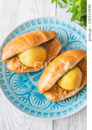 Vada Pav Indian street food served on blue plate in bright overhead composition 136523946