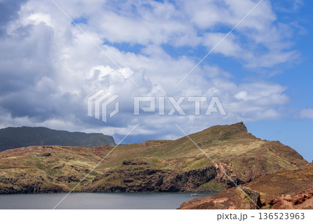 Calm Atlantic water fills Baia Abra, Madeira, as layered volcanic hills drop to the bay below Calm Atlantic water fills Baia Abra, Madeira, as layered volcanic hills drop to the bay below 136523963