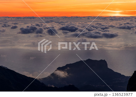Orange sunrise sky above a cloud covered ocean from Pico do Arieiro, Madeira Orange sunrise sky above a cloud covered ocean from Pico do Arieiro, Madeira 136523977