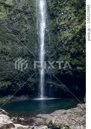 Caldeirao Verde Waterfall ends PR9 trail, plunging from basalt cliffs into a shaded emerald pool Caldeirao Verde Waterfall ends PR9 trail, plunging from basalt cliffs into a shaded emerald pool 136523995