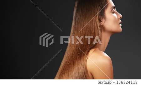 Woman Side Profile With Glossy Hair, Set Against Dark Backdrop, Dramatic Studio Lighting Highlights Length And Sheen, Luxury Salon Aesthetic, Poised Model Conveying Confidence For Premium Haircare 136524115