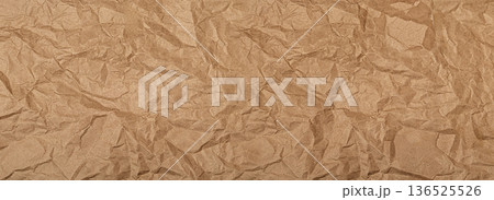 Crumpled brown kraft paper showing textured background Crumpled brown kraft paper showing textured background 136525526