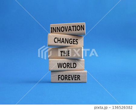 Innovation symbol. Wooden blocks with words Innovation changes the world forever. Beautiful blue background. Business and Innovation concept. Copy space 136526382