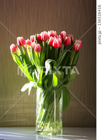 A bouquet of tulips in a vase on a home table. Freshness and cozy retro interior charm. A bouquet of tulips in a vase on a home table. Freshness and cozy retro interior charm. 136526416