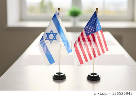 Israel and United States table flags set for diplomatic meeting, negotiation setup 136526945