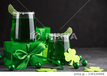 Green Cocktails with Shamrocks and Gifts. Festive St. Patricks Day Celebration Still Life Green Cocktails with Shamrocks and Gifts. Festive St. Patricks Day Celebration Still Life 136526998