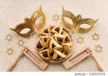 Purim celebration items with hamantashen, masks, gragger, and star of david Purim celebration items with hamantashen, masks, gragger, and star of david 136527035