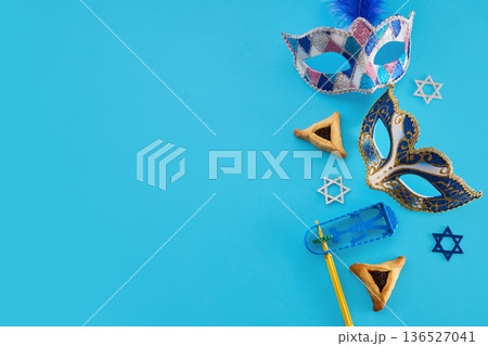 Purim jewish holiday flat lay with hamantaschen and masks 136527041