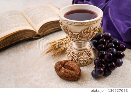 Holy communion elements with bible, chalice, and grapes Holy communion elements with bible, chalice, and grapes 136527058