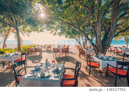 Relaxing evening beach cafe outdoor seating luxury Maldives island resort decor Relaxing evening beach cafe outdoor seating luxury Maldives island resort decor 136527762