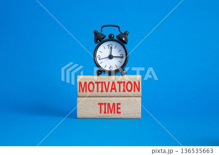 Motivation Time symbol. Concept word Motivation Time on wooden blocks. Beautiful blue background with alarm clock. Business and Motivation Time concept. Copy space 136535663