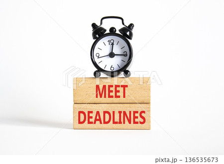 Meet Deadlines symbol. Concept word Meet Deadlines on wooden blocks. Beautiful white background with alarm clock. Business and Meet Deadlines concept. Copy space Meet Deadlines symbol. Concept word Meet Deadlines on wooden blocks. Beautiful white background with alarm clock. Business and Meet Deadlines concept. Copy space 136535673