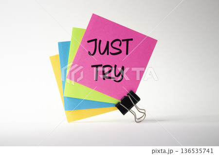 Just try symbol. Pink sticky note with words Just try. Beautiful white background. Business and Just Try concept. Copy space. 136535741