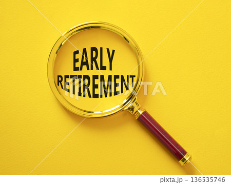 Early Retirement symbol. Magnifying Glass with words Early Retirement. Beautiful yellow background. Business and Early Retirement concept. Copy space. 136535746
