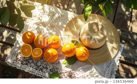 Orange with Straw Hat on Rustic Wooden Table Orange with Straw Hat on Rustic Wooden Table 136536460