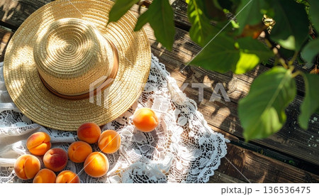 Apricots with Straw Hat on Rustic Wooden Table 136536475