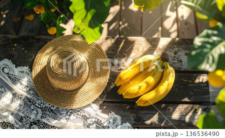Bananas with Straw Hat on Rustic Wooden Table 136536490
