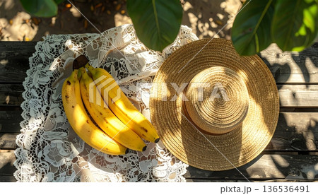 Bananas with Straw Hat on Rustic Wooden Table 136536491