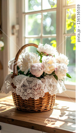 Picnic Basket with Peonies on Wooden Counter in Rustic Cottage Kitchen 136536589