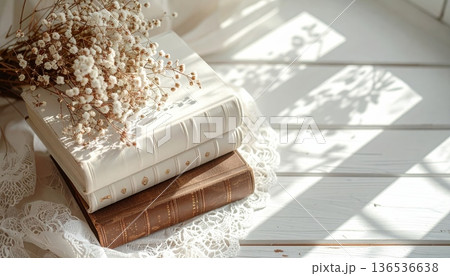 Vintage White and Brown Book Stack on White Desk with Lace Cloth 136536638