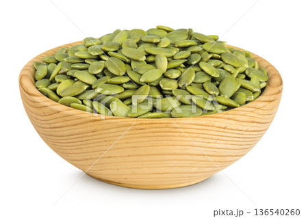 Peeled pumpkin seeds in wooden bowl isolated on white background 136540260
