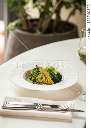 Grilled broccoli with green herb sauce 136540896