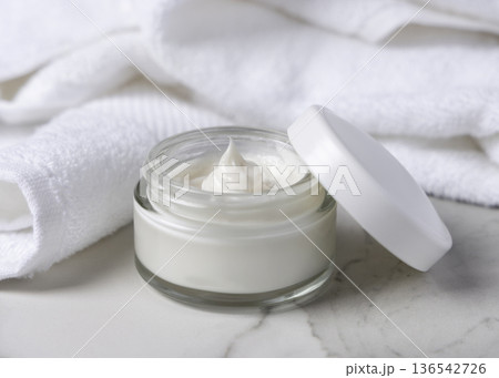 Mockup of opened face cream jar with blank lid on stone, unbranded cosmetic packaging in spa hotel bathroom Mockup of opened face cream jar with blank lid on stone, unbranded cosmetic packaging in spa hotel bathroom 136542726