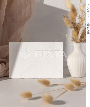 Mockup of blank card with beige and brown natural decor, boho wedding stationery, hard shadows Mockup of blank card with beige and brown natural decor, boho wedding stationery, hard shadows 136542737
