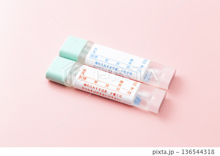 ピンク背景に大腸がんの検便キット 136544318