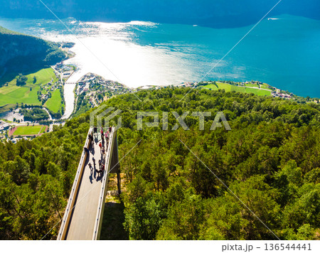 Tourist people enjoying fjord view on Stegastein viewpoint Norway Tourist people enjoying fjord view on Stegastein viewpoint Norway 136544441