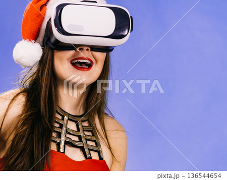 Girl watching 3d film tour in virtual reality glasses. 136544654